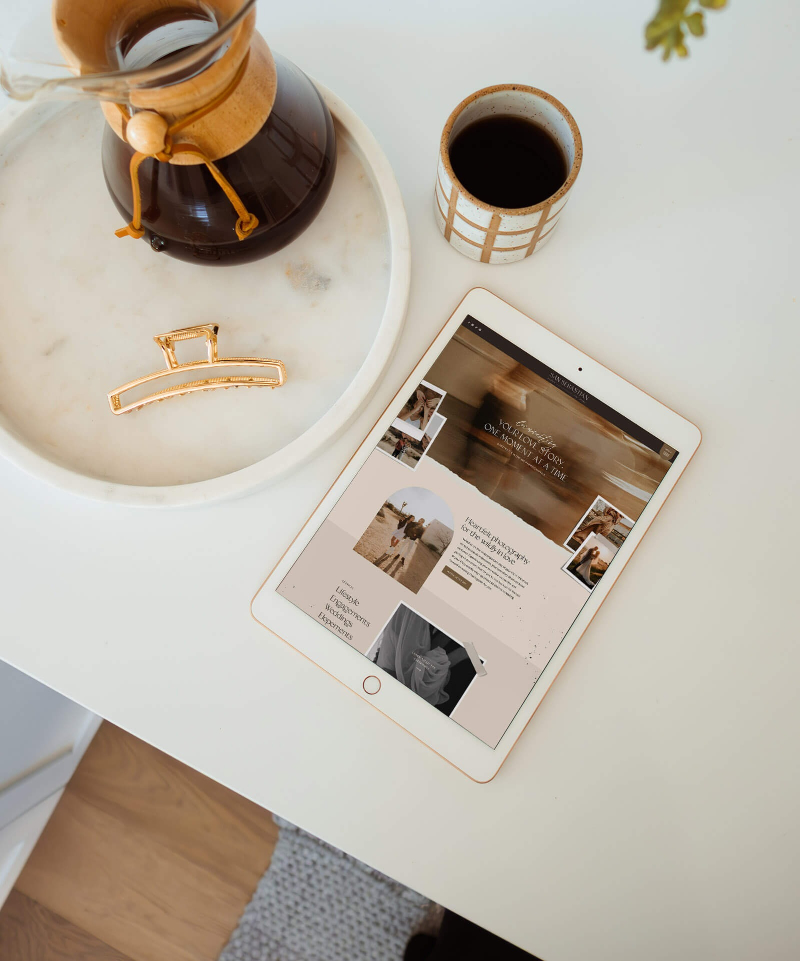 Tablet displaying a website next to coffee and hair clip, representing Showit vs Squarespace comparison.